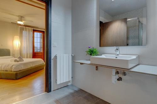 圣塞瓦斯蒂安Villa Oasis by SanSe Holidays的一间带水槽的浴室和一张位于客房内的床