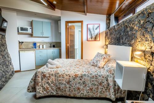 拉奥罗塔瓦Estancia Dacil的一间卧室设有一张床和石墙