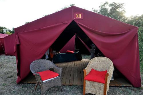罗马Tenda a Roma World的红色帐篷前面设有两把椅子