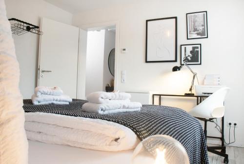 罗拉赫BlackNCozy - Design Appartement mit Boxspringbett und Balkon的白色卧室,床上配有毛巾