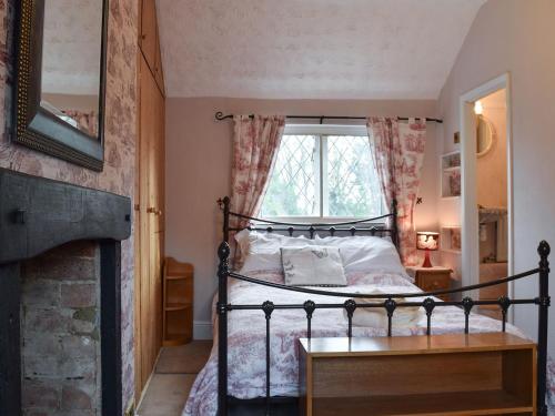阿什比圣勒杰斯Rebeccas Cottage的一间卧室设有一张床和一个窗口