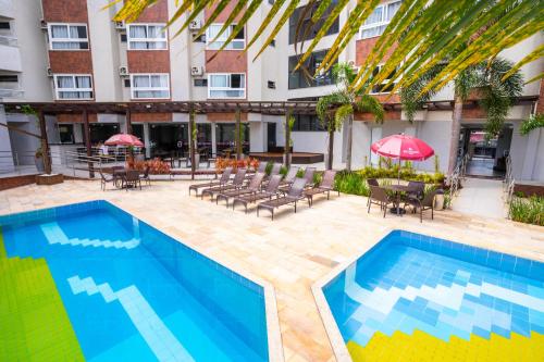 弗洛里亚诺波利斯Boulevard Beach Canasvieiras Hotel的大楼前的游泳池
