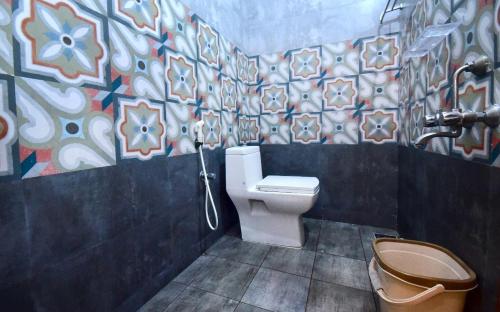 蓬蒂切里Dj Villa的一间带卫生间的浴室和墙上的绘画