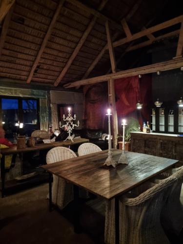 图默利拉4B Österlen Bed & Breakfast的用餐室配有带蜡烛的木桌