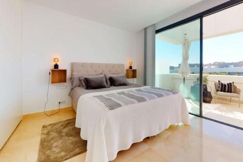 卡拉德米哈斯Luxury Townhouse in La Cala De Mijas的一间带大床的卧室和一个阳台