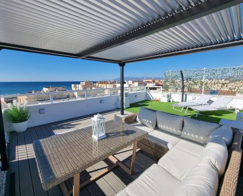 埃尔卡沃德加塔Ático Los Flamingos. Exclusive terrace with views的一个带沙发和桌子的庭院