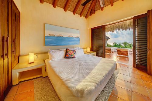 锡瓦塔塔内霍Residences at Las Palmas的一间卧室配有一张床,享有海景