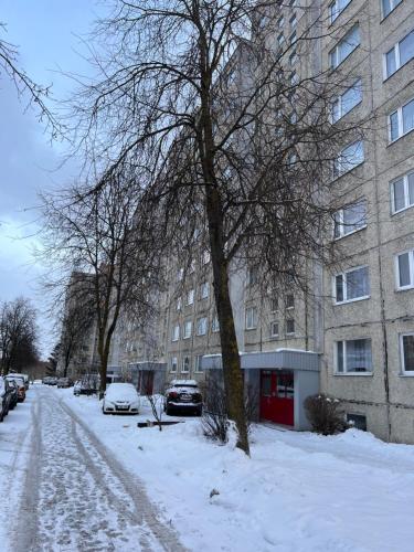 塔林Kärberi Apartments的大楼前有雪覆盖的街道