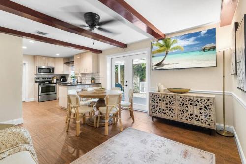 西棕榈滩Tropical Oasis Located Near Lake With Pool and Hot Tub的厨房以及带桌椅的用餐室。