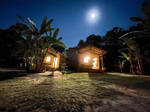 戈亚斯Pousada Flor de Laranjeira的天空中月亮的夜晚房屋