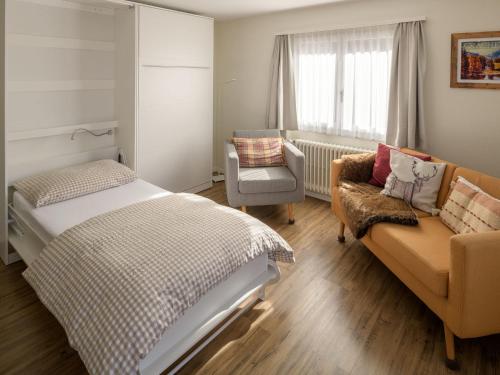 格雷兴索尔单内拉公寓的一间卧室配有一张床、一张沙发和一把椅子