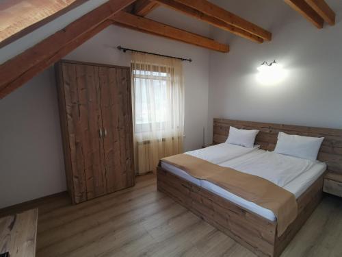 梅迪亚什Hanul Greweln的一间卧室设有一张大床和一扇木门