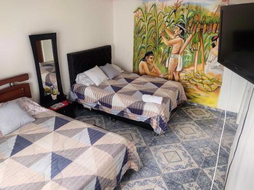 波哥大La Cachaca的一间设有两张床的客房,墙上挂着一幅画