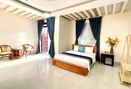 胡志明市Hoa De Nhat Hotel- Sân Bay Tân Sơn Nhất的卧室配有一张床和一张桌子及椅子