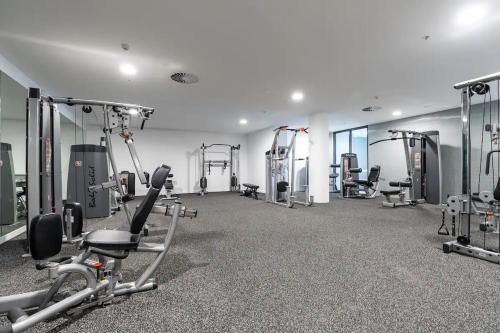 堪培拉New & Modern Loft 1bd w/Pool&Gym的健身房设有数台跑步机和有氧运动器材