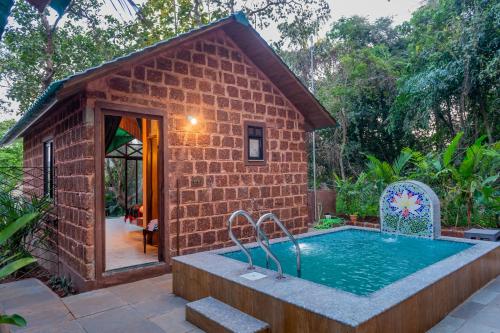 CurtorimNirvana Hill Resort的一座砖砌建筑,前面设有游泳池