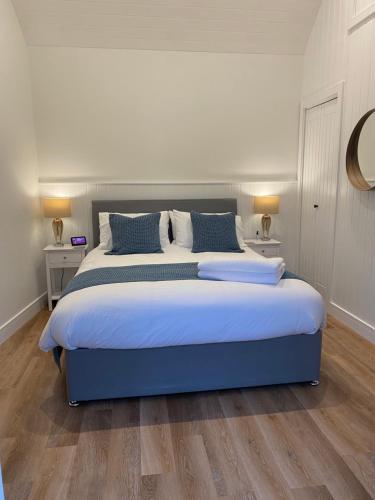 普里茅斯Rural Retreat in Devon的一间卧室配有一张带蓝色枕头的大床