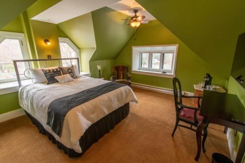 海伦娜Pope House - Hist. Mansion - The Green Suite的一间拥有绿色墙壁的卧室和一张位于客房内的床
