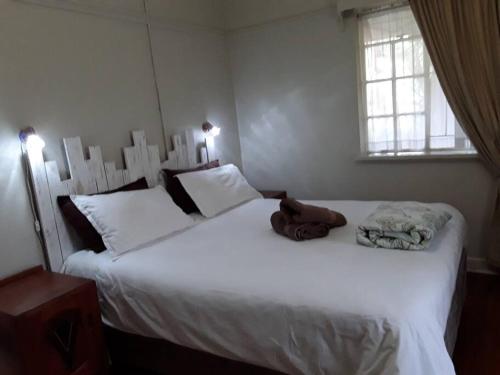 上瓦特法尔Climber's house的一间卧室设有两张带白色床单的床和窗户。