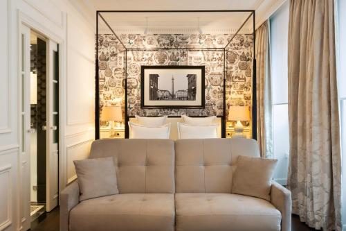 巴黎开普勒酒店的客厅的墙上设有沙发