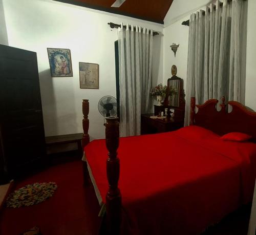 Maggona WestRoselin Villa by L2G的一间卧室配有红色的床和红色毯子