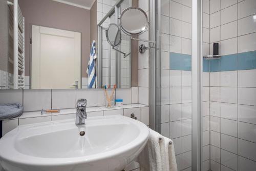 兰图姆TUI BLUE Sylt的白色的浴室设有水槽和镜子