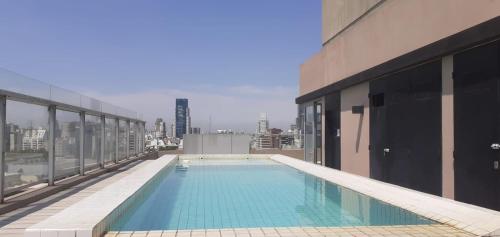 布宜诺斯艾利斯Apartamento Av kennedy y Cerviño a metros embajada EEUU的建筑物屋顶上的游泳池