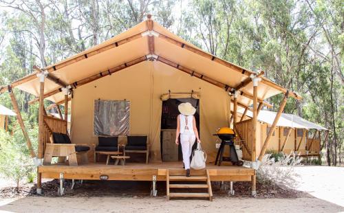 KoondrookKoondrook Glamping Retreat的站在小黄帐篷前的妇女