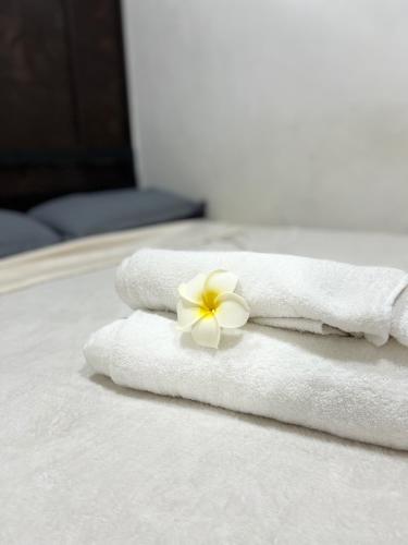General TriasGCASH - Taal cozy private homestay with PRIVATE attached bathroom in General Trias - Pink Room的床上的白色毛巾和花
