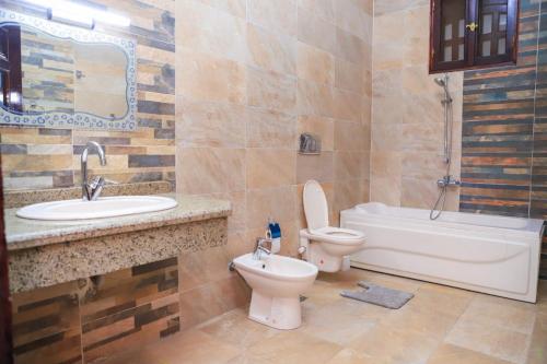 卢克索Tomorrow Land villa的浴室配有卫生间、盥洗盆和浴缸。
