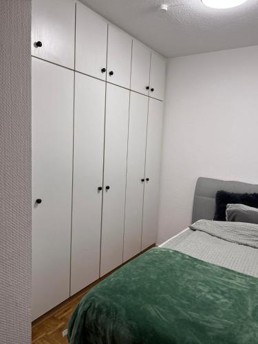 吕登沙伊德Zentral gelegenes Apartment - DSL, Küche, Balkon, Parkplatz的卧室配有白色橱柜和1张床。