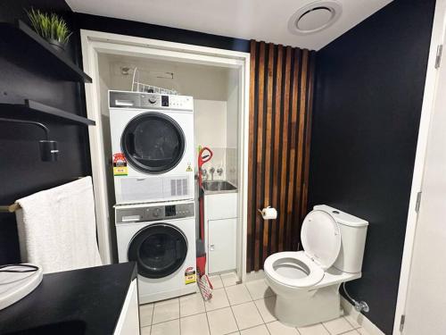 布里斯班S&P - Festival的一间带卫生间、洗衣机和烘干机的浴室