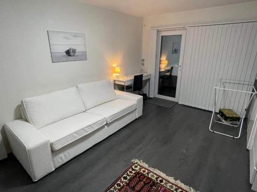LyckebyÖLJERSJÖ COTTAGE的客厅配有一张白色沙发,配有一张桌子