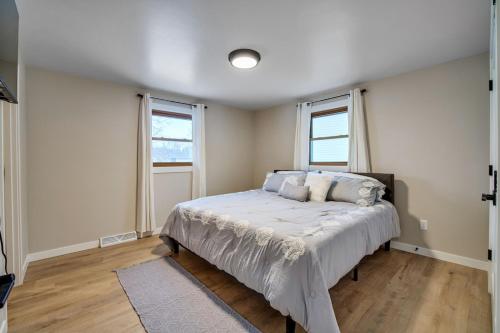 绿湾Green Bay Stay的一间卧室设有一张床和两个窗户。
