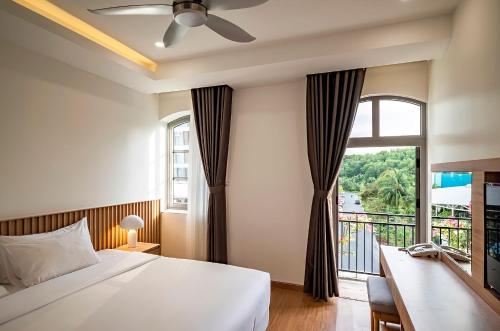 富国Ann Hotel & Spa Khem Beach PQ的一间卧室设有一张床和一个大窗户