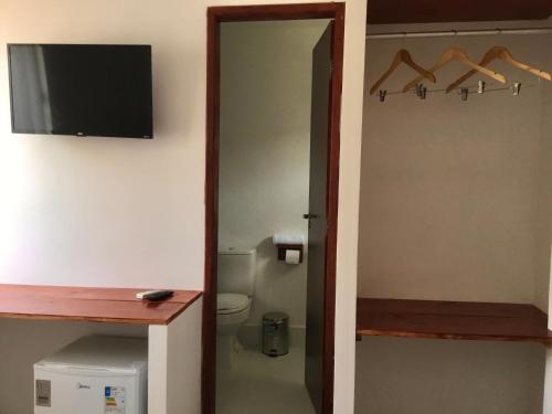 马拉戈日Recanto de Maragogi的一间带卫生间的浴室和墙上的电视