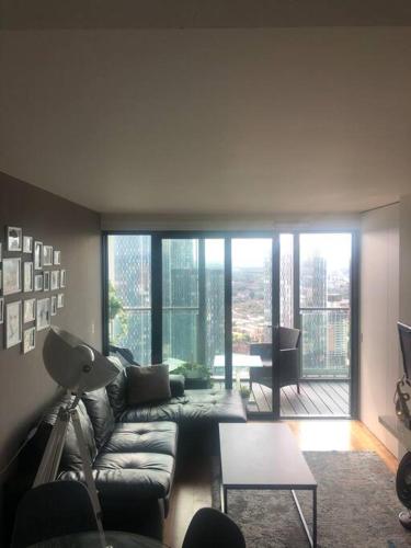 曼彻斯特Luxury apartment stunning views的客厅配有沙发和桌子