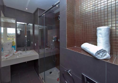 乌季达Relax Hôtel Oujda的一间带玻璃淋浴和水槽的浴室