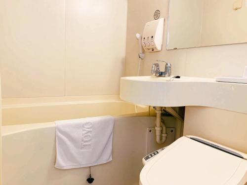 釜山Toyoko-Inn Busan Jungang Station的白色的浴室设有水槽和卫生间。