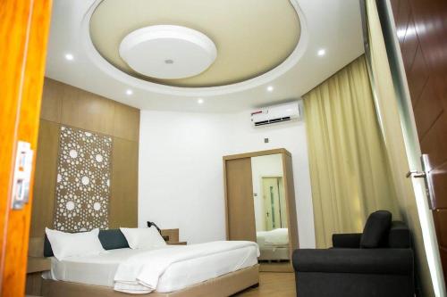 IbrāSAJ Farm Inn的卧室配有白色的床和天花板