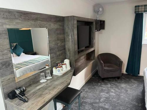 金洛赫利文麦克唐纳酒店及小屋的客房设有一张床、一张书桌和电视