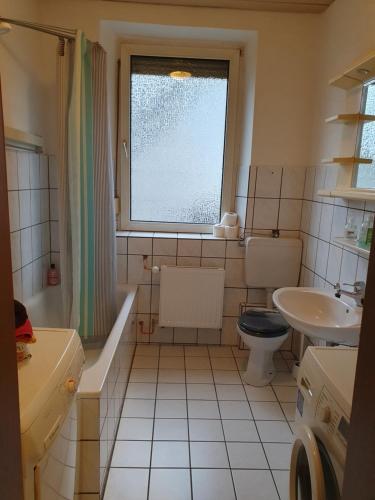 维利希Ferienwohnung Linden 87的一间带水槽和卫生间的浴室以及窗户。