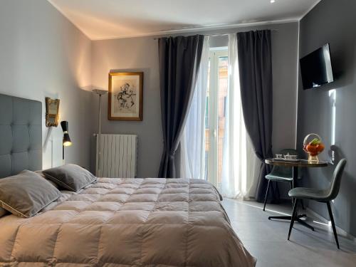 巴勒莫Dimora San Gregorio Luxury Rooms的一间卧室配有一张床、一张桌子和一个窗户。