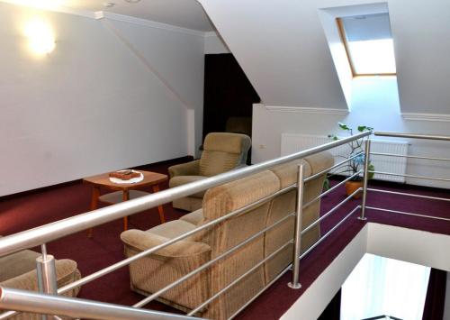 莫尔Belvárosi Vendégház的客房设有带椅子和桌子的楼梯。