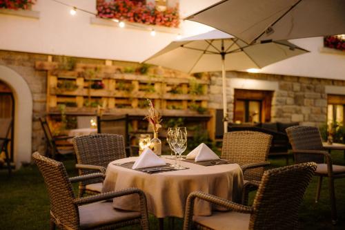 采尔马特Alpine Hotel Perren的餐厅内一张桌子、椅子和遮阳伞