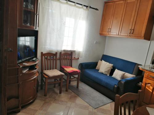 MeloGoverno's House的客厅配有蓝色的沙发和电视