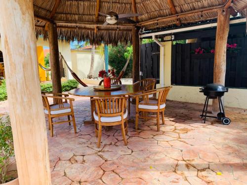 棕榈滩蛋白石之家酒店的一个带桌椅和烧烤架的庭院