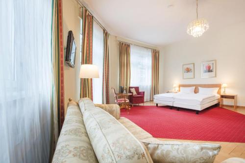 卡尔斯鲁厄马克格拉弗勒酒店的客厅配有床和沙发