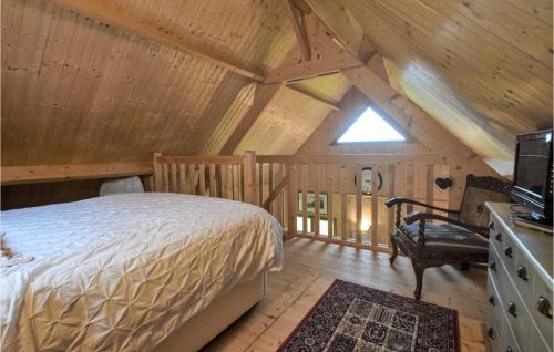 Saint-Georges-en-AugeBeautiful Home In Saint-georges-en-auge With Wifi的木制阁楼卧室配有一张床
