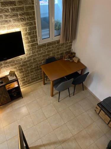 拉夫里翁Small cosy house Lavrion的一间带桌椅和电视的用餐室